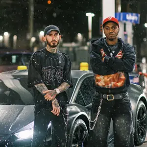 Two men standing in front of a Lamborghini at a gas station