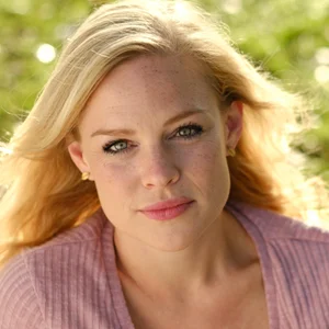 portrait of a blonde lady with pink lipstick