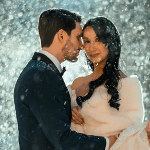 a wedding couple pose in rain