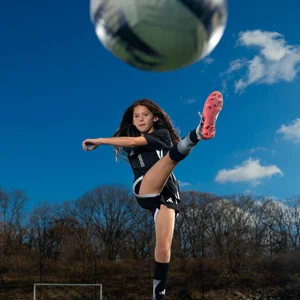 soccer player kicking a ball