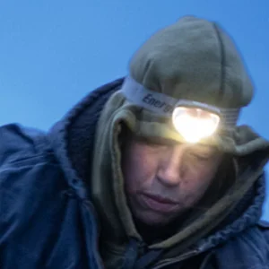person wearing a headlamp and a hoodie