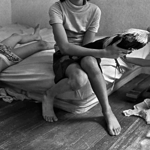 a flustered mother sits on a mattress