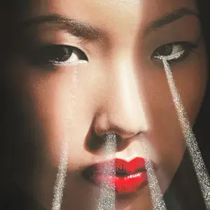 Close-up of woman's face with light beams shooting out of her eyes and nostrils