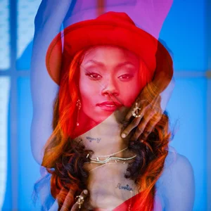 model in a red hat poses