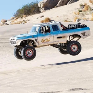 a truck hangs in midair after after jumping from a dune
