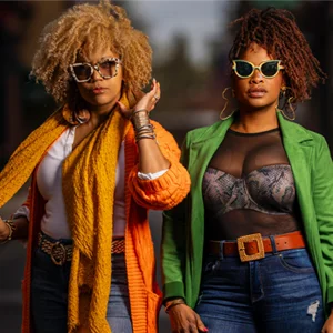 two women in colorful clothing pose