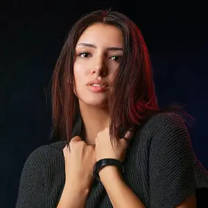 Model with brown hair and red accent lighting