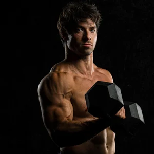 a buff model poses curling a dumbbell