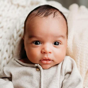 a baby stares into the camera