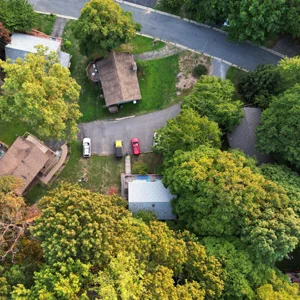 aerial drone photo of a house in the woods.