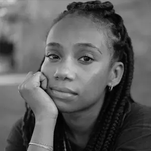 Girl staring, with her hand on her face