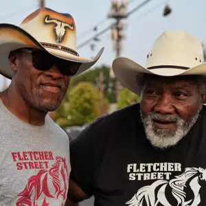 Two men from Fletcher Street Urban Riding Club in cowboy hats
