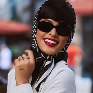 Happy woman with sunglasses, fashionable head scarf, and red lipstick
