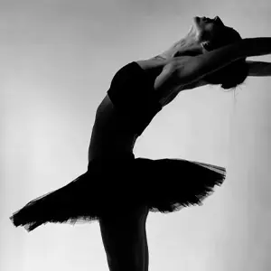 Almost silhouette of ballerina in tutu arching her back
