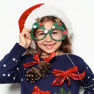 Girl with green holiday glasses and a santa hat