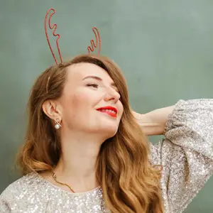 Woman with red hair wearing reindeer antlers