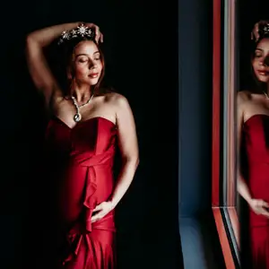 pregnant model poses in front of mirror