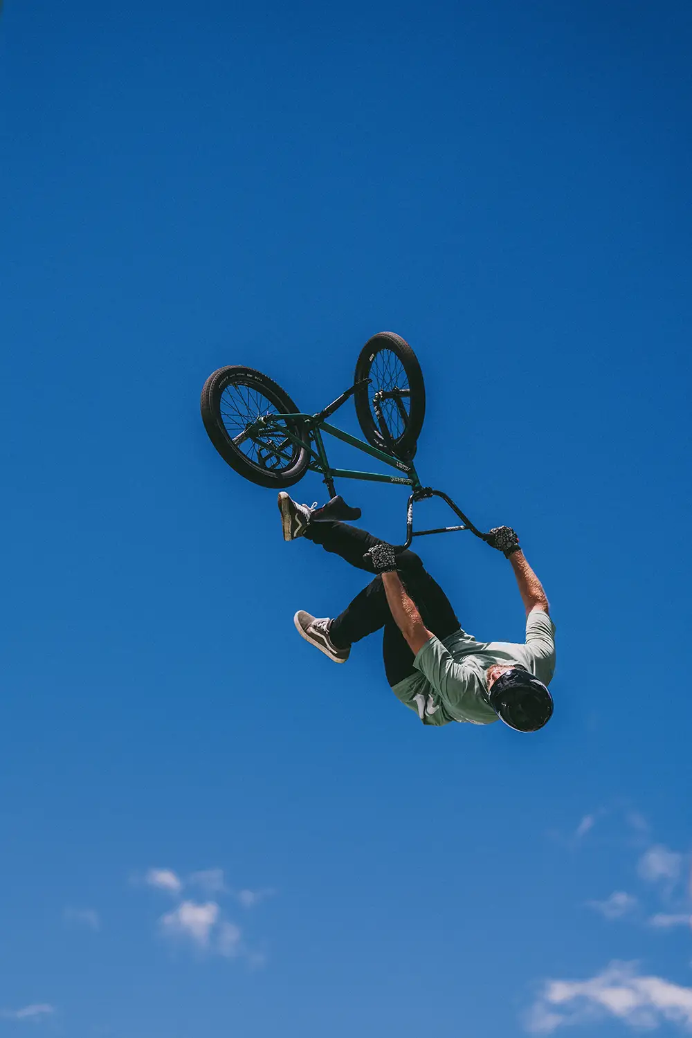 An airborne BMX rider in the middle of a backflip