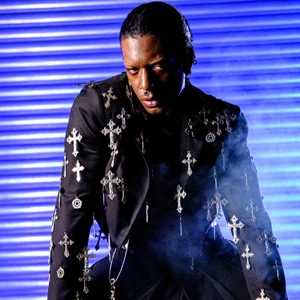 a guy dressed as the matrix poses in front of a blue shutter