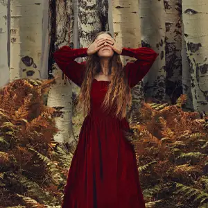 Woman in red dress in the woods