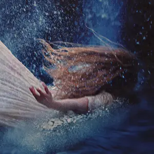 Woman in white gown crashing into a pool of water