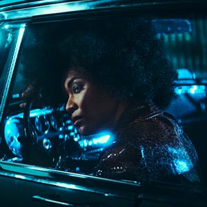 photo of a blue lit driver in a car