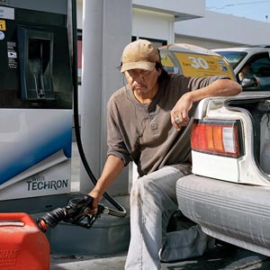 photo of a man filling up a gas tank