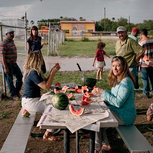 photo of people positioned around a picnic table
