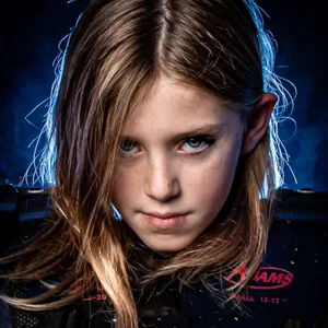 a kid in sports gear looks into the camera