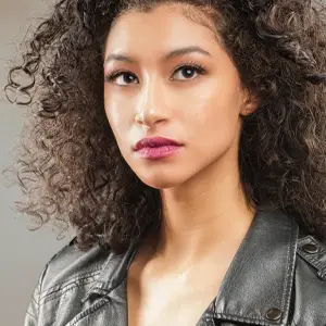 Model with curly hair and leather jacket