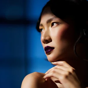 glamour model with dark lipstick poses