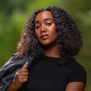 Model with jean jacket over one shoulder