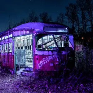 Abandoned train car in field at night
