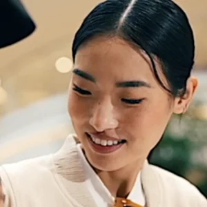 a dark haired woman smiles 