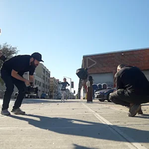 a man holding a camera captures a skateboarder