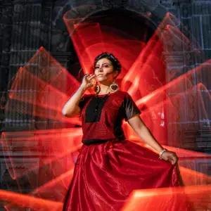 Model in red dress with red light painting effects