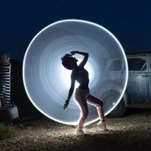 Light painting behind model in junkyard