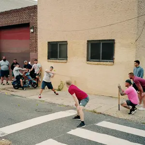 Men playing stick ball in the street